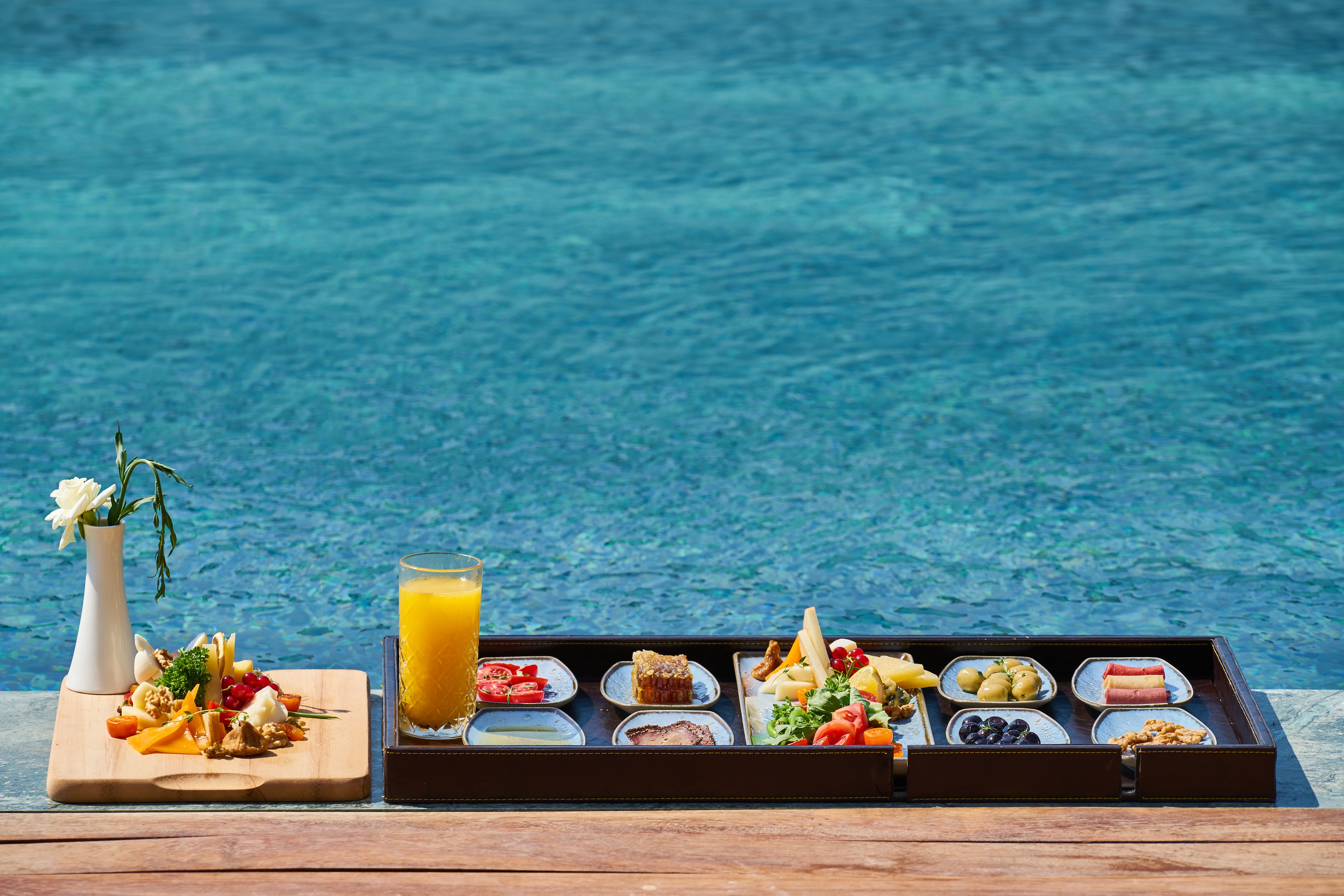 hospitality - a tray with breakfast food by the pool